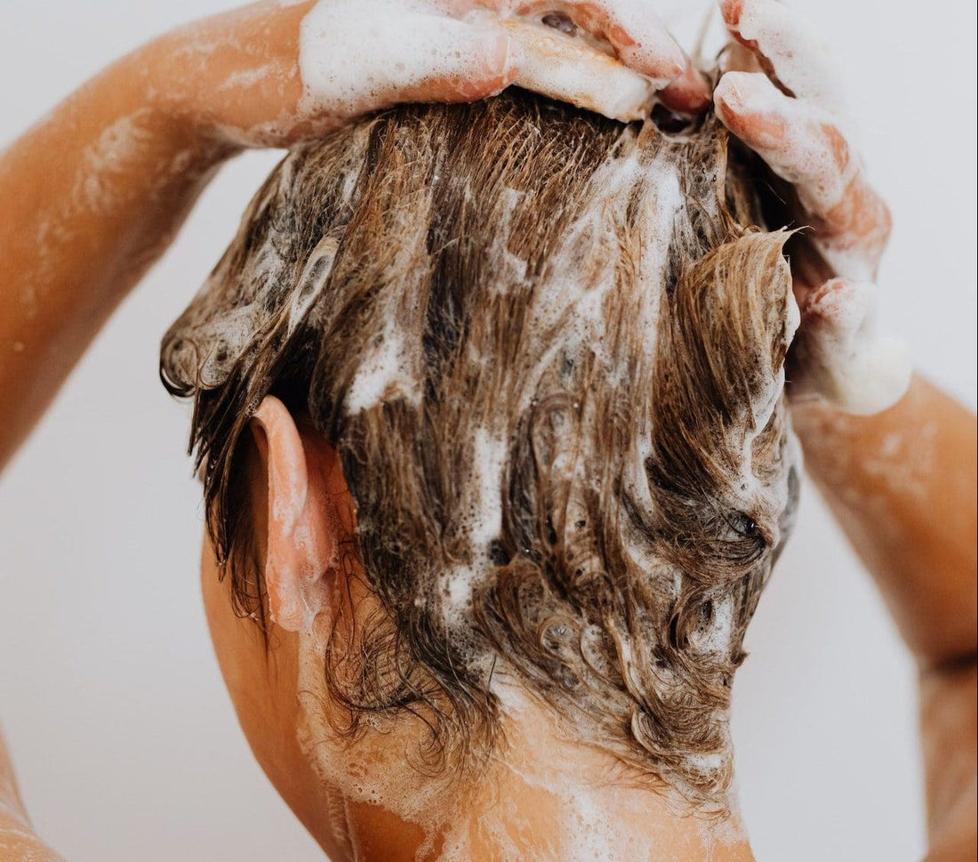woman washing hair with goats milk shampoo bar|juniper lemon and rosemary shampoo bar by the little goat soap company