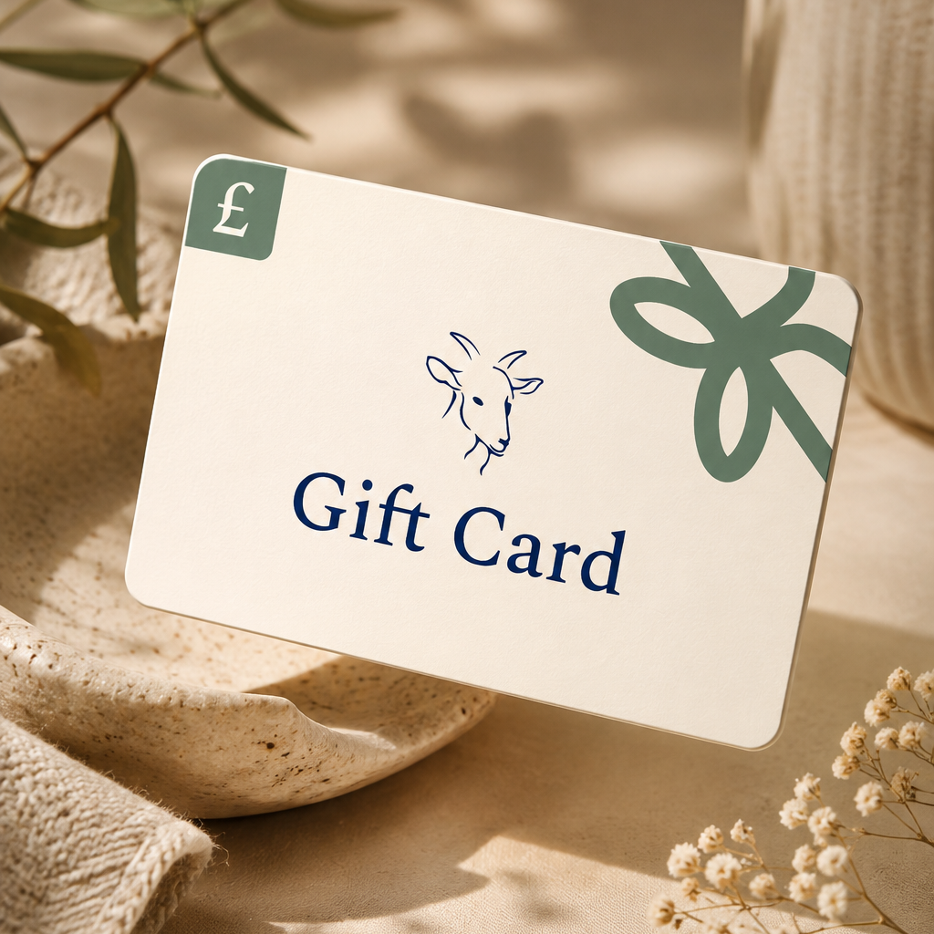 A cream gift card with a green bow graphic and the words 'Gift Card' and a pound symbol, styled on a beige surface with dried flowers and soft shadows.
